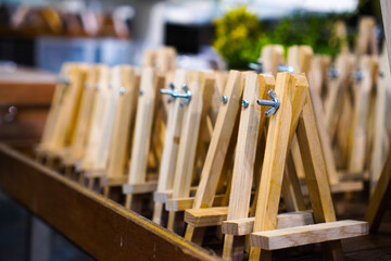 Small wooden easel in a store. A wooden easel frame for drawing paintings or other creations.
