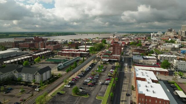 Aerial Shot Of Residential City With Tranquil River, Drone Flying Forward Over Parking Lot - Memphis, Tennessee