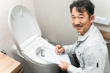Fototapeta premium トイレの点検をする修理業者 ライフスタイルイメージ
