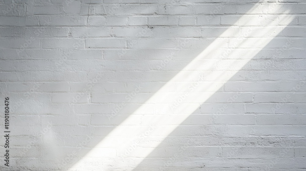 Poster rays of light creating abstract patterns on a white cement wall as sunlight streams through a narrow