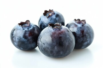Obraz premium A cluster of fresh blueberries arranged on a white surface, creating a clean and minimalistic aesthetic against a white background.