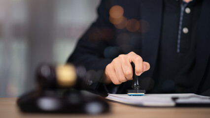 Wooden judge gavel on table, justice in punishment of offenses and criminal verdicts, concept of law and justice, Lawyer or judge examining documents, legal service lawyer, court proceedings