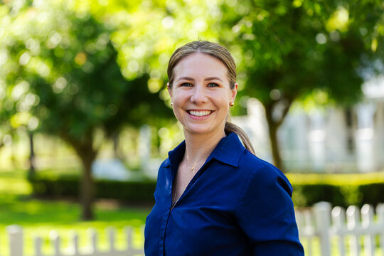 Happy businesswoman employee smiling for headshot portrait outside