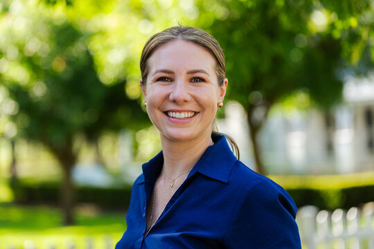 Happy businesswoman employee smiling for headshot portrait outside