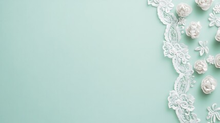 Fototapeta premium White Lace and Flowers on Mint Green Background