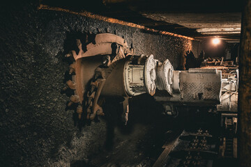 A powerful coal mining machine with massive metal teeth, standing as a symbol of industrial strength and hard work, showcasing the legacy of coal mining in its raw and mechanical form.