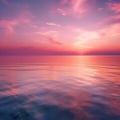 Obraz premium Pink Sunset Over Calm Ocean Waters Reflecting Sky