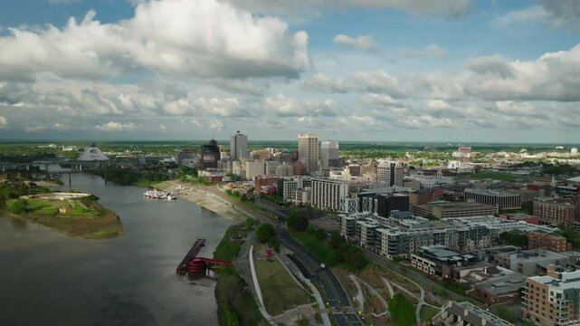Aerial Scenic View Of Residential City Under Clouds, Drone Flying Backwards Over Rippled River - Memphis, Tennessee