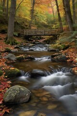 Fototapeta premium Autumn leaves frame a flowing forest stream and waterfall cascading over rocks in a vibrant natural landscape