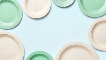 Colorful plates arranged in circular pattern on bright backdrop, simplicity, No Dirty Dishes Day, with copy space