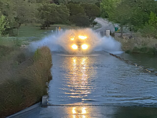 Truck speeds through low water crossing in central Texas.