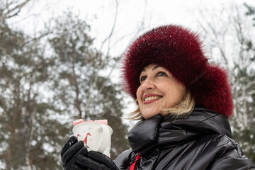 woman in a park with hot cacao cap