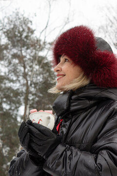 smiling woman 50s with cacao in her hands in winter park