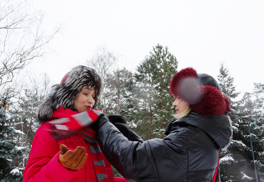 two women on a walk in a winter park, copy space
