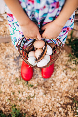 Basket of Chicken Eggs with a Feather and Red Boots