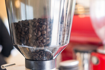 Espresso coffee machine with roasted coffee beans at cafe