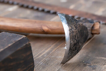 close-up of a sharp ax scraper for removing bark on a table