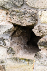 hole in a stone wall close-up, a hole in the wall