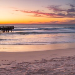 A tranquil beach scene with soft golden sand, calm waves, and a colorful sunset reflecting on the water. 