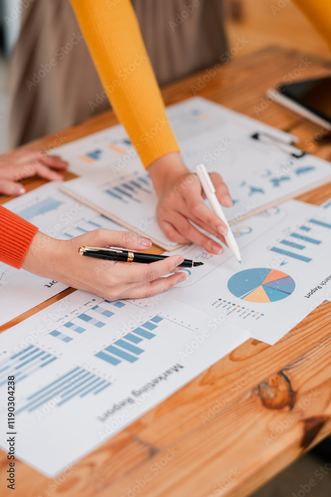 Poster collaborative teamwork analyzing business reports with graphs and charts on wooden desk in modern of