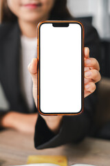 Businesswoman Holding Smartphone with Blank Screen for Mockup in Office Setting
