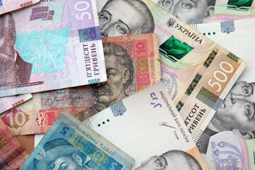 Big amount of different ukrainian hryvnia currency money bills in pile