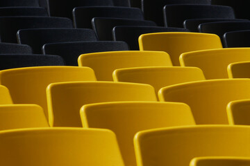 Fototapeta premium mix of black and yellow seats of an outdoor theater