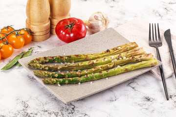 Grilled asparagus sprouts served red pepper