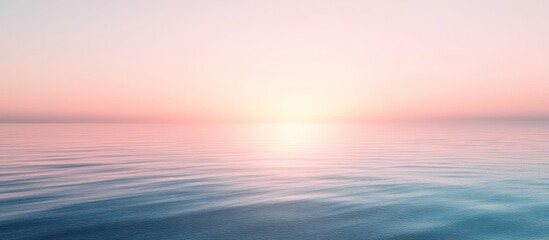 Obraz premium Serene sunset over calm ocean water.