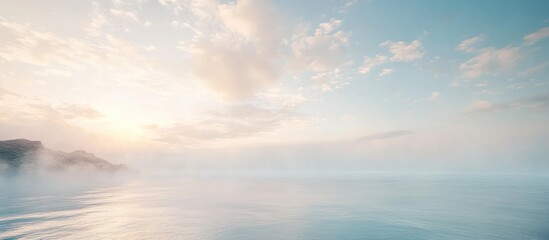 Fototapeta premium Serene sunrise over misty water with distant mountains.