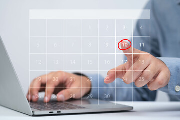 A person interactively selecting a calendar date on a laptop, showcasing digital planning and organization.