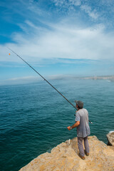 Dramatic Cliffside Fishing Scene in Algarve Portugal at Sunset