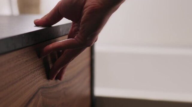 Slow motion man hand open and close batroom cabinet drawer closeup