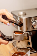 The process of making coffee at home. Coffee machine. Ground coffee.