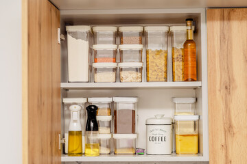 Organization of space in the kitchen cabinet. Organizers for loose products.
