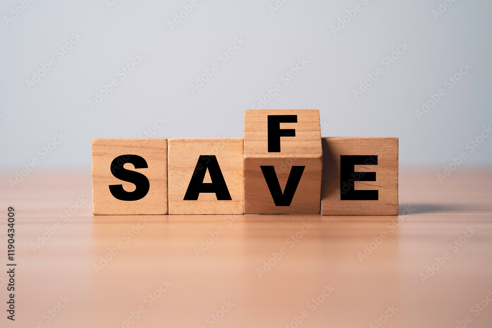 Aufkleber wooden block cube change between save and safe wording for money saving to safe investment concept.