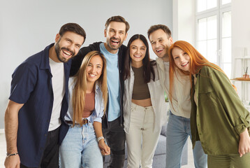 Group of happy smiling young people friends or colleagues in casual clothes looking cheerful and...