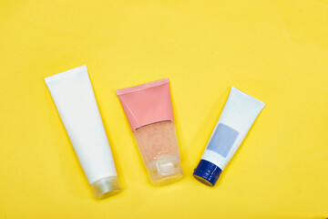 Beauty cosmetics tube; branding mock up isolated on yellow background. Package for hand cream or scrub. Beauty cosmetics tube, branding mock up