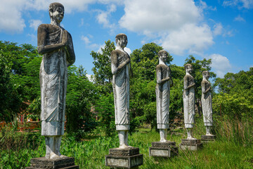 Religious statues in temple ruins, jungle reclaiming - Battanbang, Cambodia