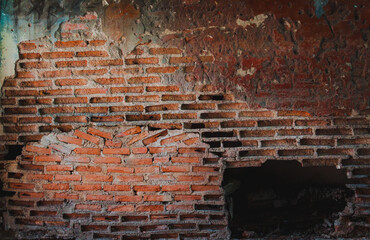 Old orange brick wall background with cracked brick wall with dark edges.