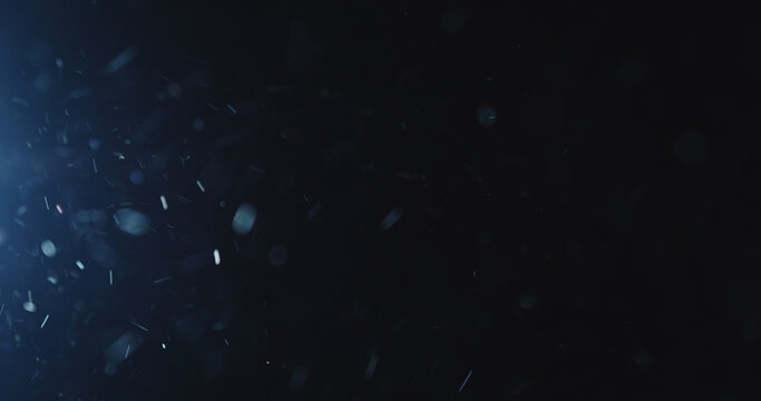 natural dust particles flow in air on black background