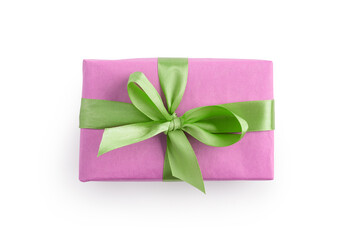 Top view of pink gift box with green ribbon bow isolated on white background