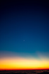 sunset over the sky and the moon