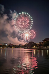 Fototapeta premium Colorful Fireworks Display Over Calm Lake at Night with Reflections