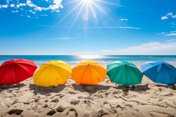 Five bright umbrellas stand in a row on a sandy beach with the sun shining overhead, Bright sun shining on a sandy beach with colorful umbrellas