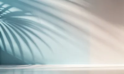 Fototapete Badezimmer Minimalist simple background for design with beautiful light shadow from palm leaves on wall, gentle calm pastel muted shades of blue and beige with smooth color transition.  © Laura Pashkevich