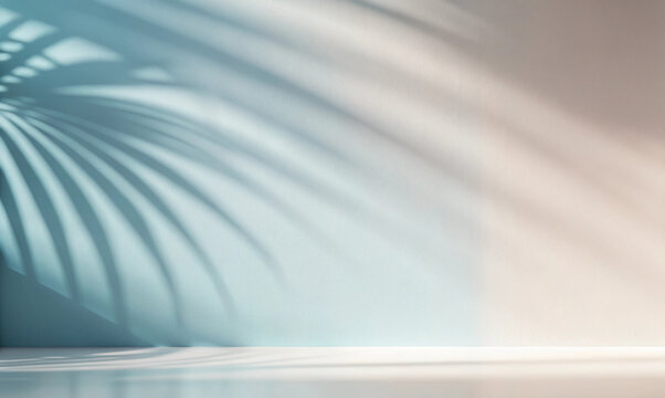 Minimalist simple background for design with beautiful light shadow from palm leaves on wall, gentle calm pastel muted shades of blue and beige with smooth color transition.