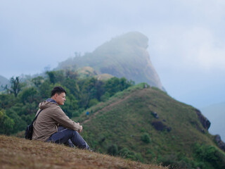 Naklejka premium Young Asian man hiking in the forest in Chiang Mai, Thailand