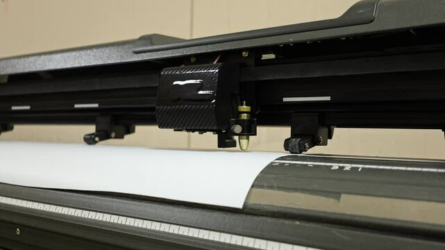 Cutting plotter close-up. The process of cutting a vinyl film.