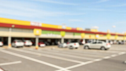 Blurred photo of outdoor parking lot in community shopping center.